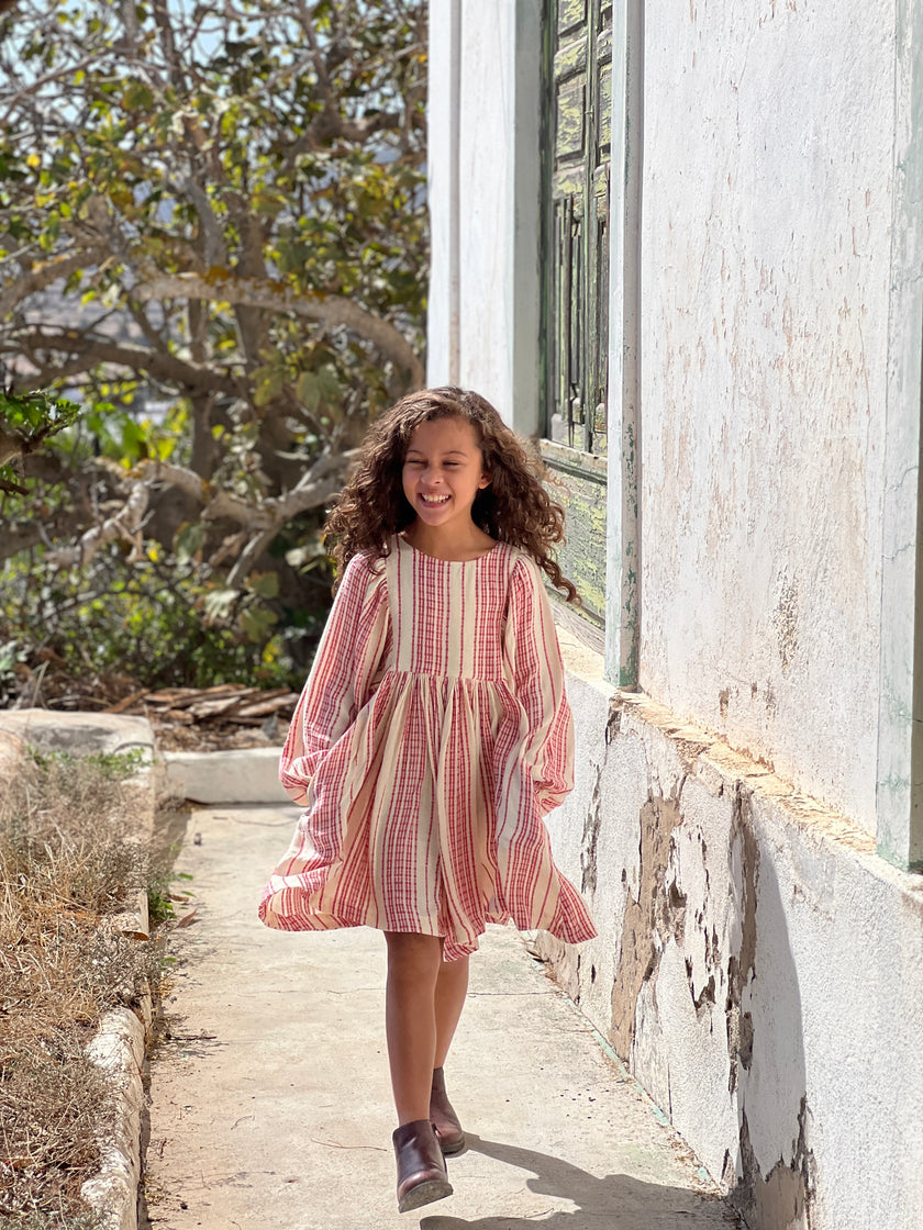 Pretty knee length dress with circle skirt and gathered sleeves. In our pretty red and white stripe fabric.